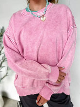 Pink mineral wash distressed cotton sweatshirt with white stitching ribbed hem machine wash care instructions included