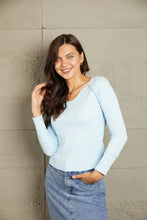 Light blue mineral wash exposed seam long sleeve women’s top with V-neck