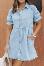 Light blue mineral wash denim dress with short puffed sleeves and button front featuring ruffle details