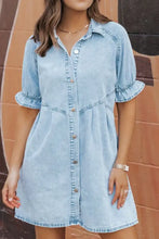 Light blue mineral wash denim dress with short sleeves and button front featuring ruffle details