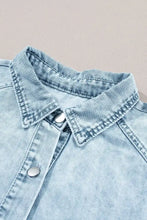 Light-wash denim dress with classic collar silver buttons featuring mineral wash ruffle sleeve detail