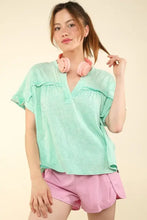 Woman in mint green washed knit top with notched short sleeve and pink shorts set