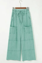 Mint green wide-leg cargo pants with drawstring waist and pockets