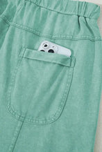 Mint green wide-leg cargo pants with drawstring waist and phone pockets