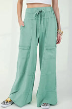 Mint green wide-leg cargo pants with drawstring waist and pockets