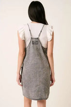 Back view of mittoshop gray denim dress with thin straps and small patch featuring mini cami denim style