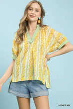 Yellow and green mix print boho blouse with floral pattern v-neckline and short sleeves with striped cuffs