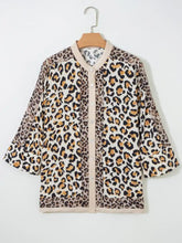 Beige and black mixed leopard patchwork button-up blouse with three-quarter sleeves and a loose fit