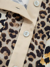 Beige satin button placket with mother of pearl buttons on mixed leopard patchwork 3/4 sleeve loose shirt