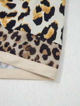Mixed leopard patchwork 3/4 sleeve loose shirt with cream base, bold black and tan spots, and satin-like hem finish