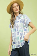 Mixed media blouse shirt in blue geometric print with ruffled short sleeves and button front collar on white background