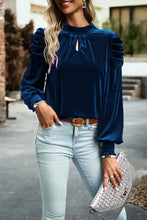Navy blue mock neck velvet blouse with puffed sleeves and ruffled details