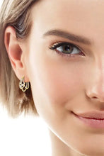 Woman’s face with 18k gold-plated sterling silver layered hoop earring