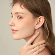 Woman wearing silver leaf shape stud earrings in 925 sterling silver