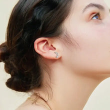 Woman’s ear with curved moissanite 925 sterling silver stud earring