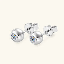 Pair of sterling silver stud earrings with round-cut cubic zirconia stone
