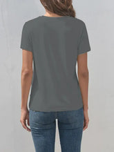 Short-sleeved dark gray motorcycle graphic t-shirt with blue jeans