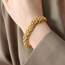 Triple-strand gold toggle clasp bracelet with textured chain design