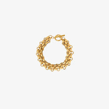 Gold-toned multi-strand toggle clasp bracelet with titanium steel accents