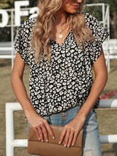 Brown ribbed clutch purse paired with multicolor v neck short sleeve leopard blouse featuring short sleeve leopard design