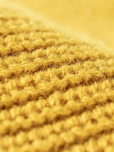 Golden distressed cuffed knit hat in mustard yellow with soft ribbed texture
