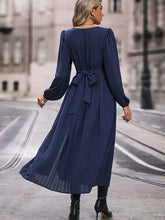 Elegant navy blue chiffon dress featuring long sleeve length and waist bow