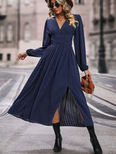 Elegant navy blue chiffon dress with long sleeve length, deep V-neck, and high slit