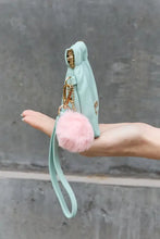 Nicole Lee USA faux leather pouch in mint green with pink pom-pom and gold-tone hardware