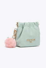 Nicole Lee USA faux leather pouch features mint green drawstring, pink fur charm, gold-tone hardware