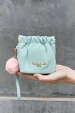 Nicole Lee USA mint green faux leather pouch features gold-tone hardware and pink pom-pom charm