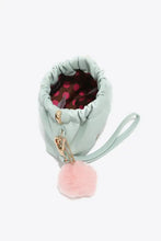 Nicole Lee USA faux leather pouch features gold-tone hardware and pink pom-pom charm