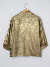 Notched 3/4 sleeve blouse with a shimmering gold metallic textured finish and three-quarter length sleeves