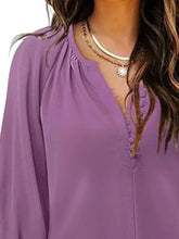 A soft lavender notched 3/4 sleeve blouse with flowing lightweight fabric and delicate front button detailing