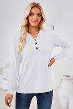 Woman in notched button long sleeve henley t-shirt