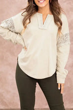 Woman in notched crochet long sleeve sweatshirt and olive pants
