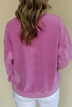 Woman in notched drop shoulder long sleeve sweatshirt, purple with back seam