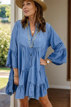 Blue denim dress with notched flare bell sleeves and v-neckline made from soft denim fabric