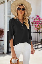 Woman in notched half button T-shirt with 3/4 sleeve length, white pants, straw hat, sunglasses, bag