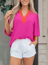 Vibrant pink and orange notched half sleeve blouse with v neckline in lightweight fabric for stylish wear