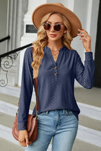 Woman in notched long sleeve T-shirt with navy textured top