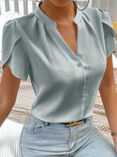A light blue satin notched neckline petal sleeve blouse with short puffed sleeves and a button-down front