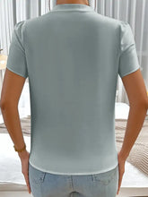 Light blue short-sleeved notched neckline blouse with subtle sheen and puffed petal sleeves made of smooth fabric