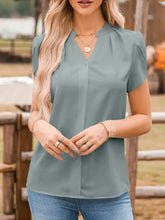 Notched neckline petal sleeve blouse in soft sage green lightweight fabric with a flattering v-neck and flutter sleeves