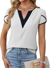 Notched petal sleeve blouse in white with black v-neck and sleeve trim featuring short sleeves and lightweight fabric