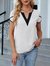 White notched petal sleeve blouse with black v-neck and sleeve trim in lightweight fabric for casual wear