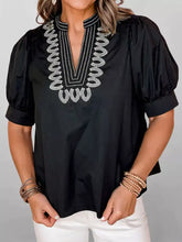 Black notched puff sleeve blouse with white embroidered detailing around the neckline in lightweight fabric