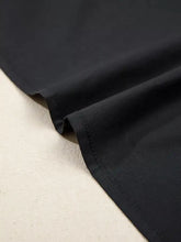 Black notched puff sleeve blouse fabric with smooth texture and neat stitching along hem for elegant finish