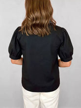 Black notched puff sleeve blouse with tailored fit and smooth fabric featuring short puffed sleeves