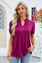 Magenta women’s notched short sleeve tunic top with V-neck pintucks