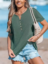 Woman in notched short sleeve t-shirt and denim shorts with net bag
